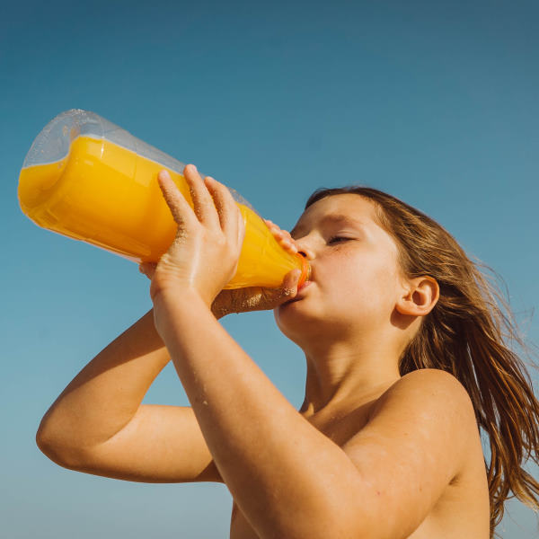 girl drinking orange juice