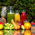 fruit, vegetables, and juice on table