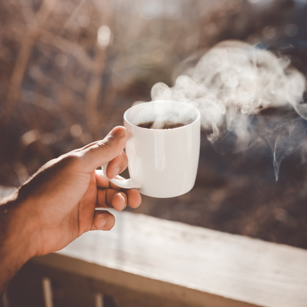 holding cup of coffee