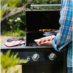 man cooking on 2-burner gas grill