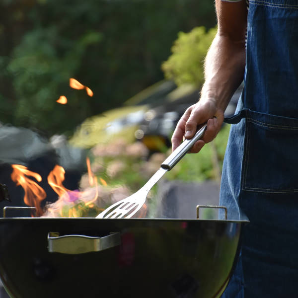 man cooking on charcoal grill