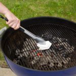cleaning charcoal grill grate with towel