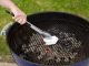 cleaning charcoal grill grate with towel