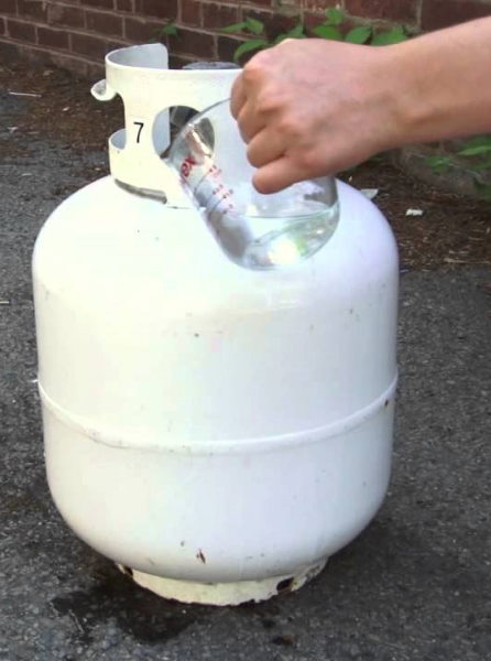 pouring water on propane tank