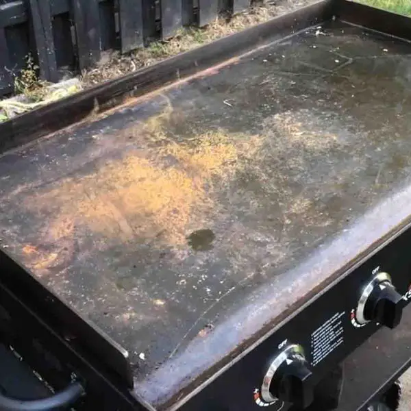 cleaning a rusty flat top grill