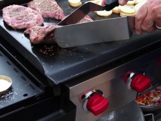 cooking steaks and potatoes on griddle