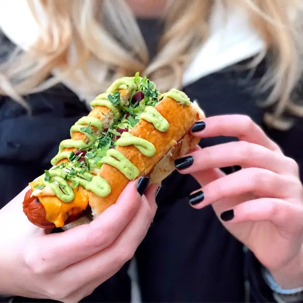woman eating hot dog