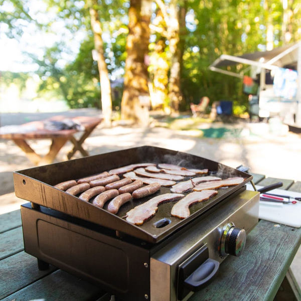 cooking bacon on griddle while camping